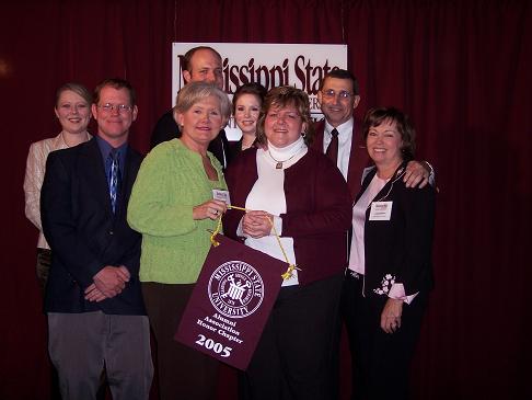 A gaggle of chapter officers and board members holding our award.